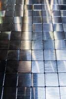 shiny steel machined blocks pavement surface background - close-up with selective focus and blur photo