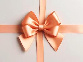 AI generated Beautiful peach satin ribbon with bow for gift decor on white photo