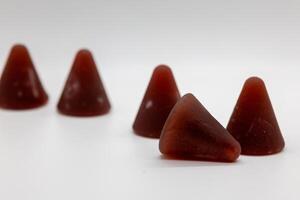 Closeup of cuberdon, a cone-shaped Belgian candy on a white background photo