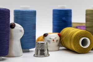 Colorful Sewing Threads with Ceramic Cat Figurines and Thimble photo