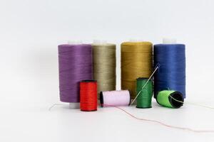 A group of spools and thread in different colors photo