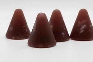 Closeup of cuberdon, a cone-shaped Belgian candy on a white background photo