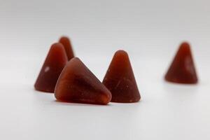 Closeup of cuberdon, a cone-shaped Belgian candy on a white background photo
