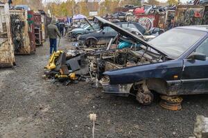 car parts at open air junkyard and used spare parts market in Kudaybergen, Bishkek, Kyrgyzstan photo