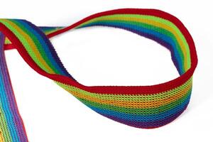 Colorful rainbow ribbon closeup isolated on white background. Colorful LGBT design. Curly, fluttering ribbon. photo