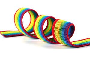 Colorful rainbow ribbon closeup isolated on white background. Colorful LGBT design. Curly, fluttering ribbon. photo