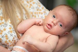 Newborn baby in mother's arms close-up. photo