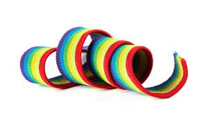 Colorful rainbow ribbon closeup isolated on white background. Colorful LGBT design. Curly, fluttering ribbon. photo