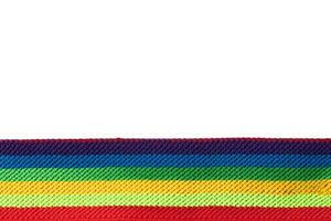 Colorful rainbow ribbon closeup isolated on white background. Colorful LGBT design. Curly, fluttering ribbon. photo