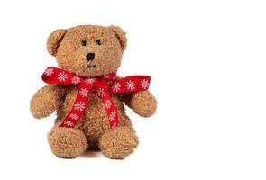 Vintage toy bear with Christmas bow on a white background. photo