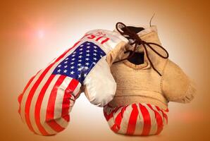 Boxing vintage gloves with USA flag on beige background photo