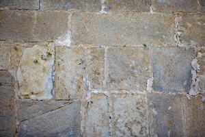 Background old wall made of porous stones of the mountainous area. Wall of an ancient church. photo
