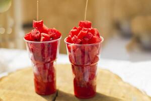 Plastic cups with watermelon slices photo
