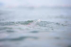 Splash sea water blue color in rosfocus. photo