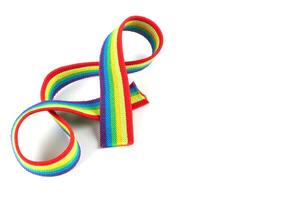 Colorful rainbow ribbon closeup isolated on white background. Colorful LGBT design. Curly, fluttering ribbon. photo