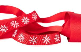 Christmas red ribbon with white snowflakes isolated. photo