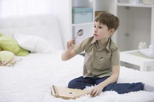 A child with a musical instrument. Boy learn to play dulcimer photo