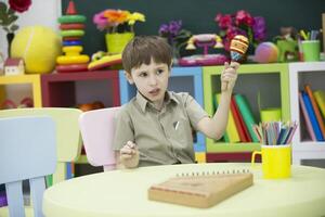 A child with a musical instrument. Boy learn to play dulcimer photo