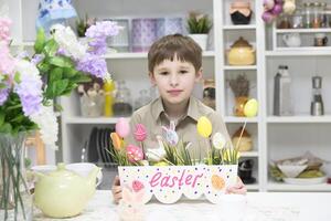 Baby in the kitchen with easter eggs photo