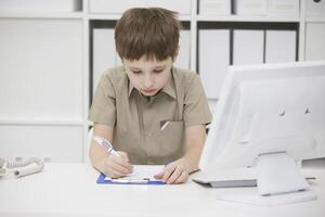 Junior school student doing homework photo