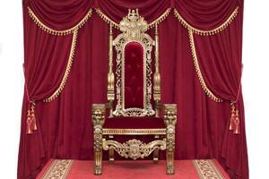 Red royal chair on a background of red curtains. Place for the king. Throne photo