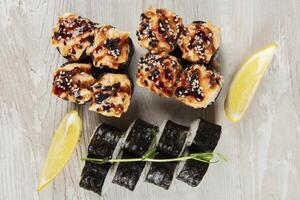 Set of various sushi rolls on a white wooden background close-up. photo