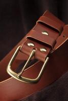 Part of a brown belt made of genuine expensive leather. photo