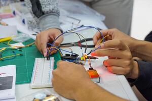 Students experiment with simple electronic circuits. Principles of traffic light circuits. Soft and selective focus. photo