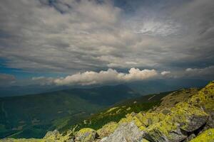 Beautiful clouds over mountains and rocks. View from the top of the mountain photo