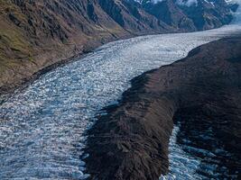 Svnafellsjkull Glacier in Iceland. Top view. Skaftafell National Park. Ice and ashes of the volcano texture landscape, beautiful nature ice background from Iceland photo