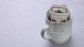 Hot water poured into a cup of roasted coffee to produce  drip coffee video