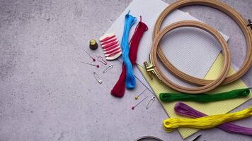 Supplies for hand embroidery.  Hoops with  canvas, scissors,  cotton threads. video