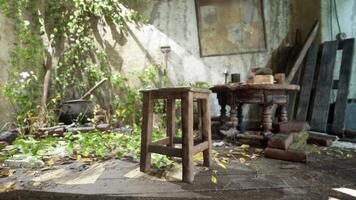 An abandoned room with a chair and table in a state of devastation video