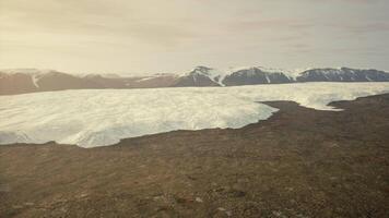 A breathtaking aerial view of a glacier surrounded by majestic mountains video