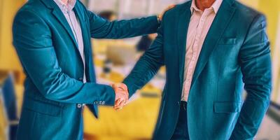 Two business man making handshake in the city. Business etiquette, congratulation, merger and acquisition concepts. photo