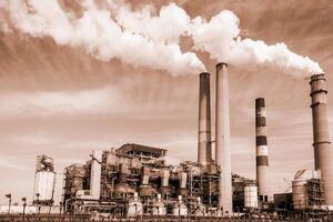 View of the thermal power plant, smoke from the chimney. Concept air pollution, global warming Toned image photo