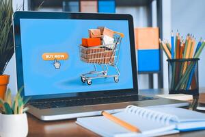 Shopping carts and laptop computers on the table used for online shopping. photo