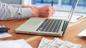 Businessman check to financial documents, he owns a startup company, he sits checking the company's financial summary prepared by the finance department. Management concept of startup photo