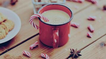 Red cup with cocoa, cookies and caramel christmas and seasonal drinks concept photo