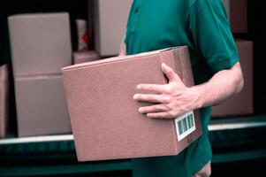 Delivery man holding cardboard boxes. Online shopping and Express delivery. copy space. man holds in his hands a big box photo