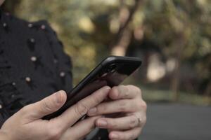 Using smartphone, phone in hand photo