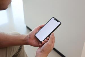 Using smartphone, hand holding phone, working from home photo