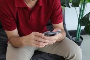 Using smartphone, hand holding phone, working from home photo