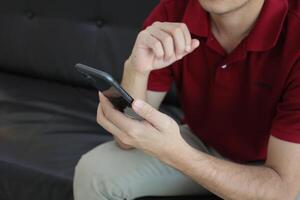 Using smartphone, hand holding phone, working from home photo