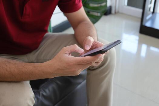 Using smartphone, hand holding phone, working from home photo