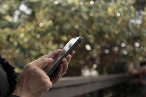 Using smartphone, phone in hand photo