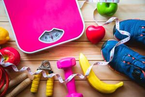 fitness concept with Exercise Equipment on wooden background. photo