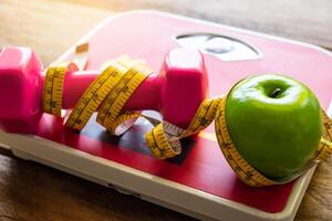 fitness concept with Exercise Equipment on wooden background. photo