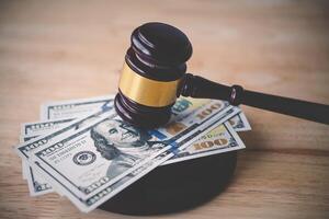 Law and justice concept. Judge hammer with the dollar placed - concept of judgment and justice. About fraud tax fines photo