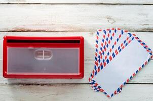 Red envelope mailboxes are placed on a wooden floor. photo